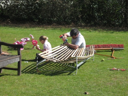 Club captain Dave Harkness repairing a catching cradle whilst a co-worker has a break!